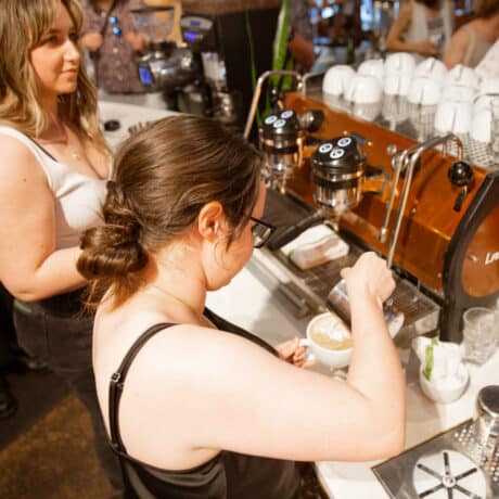 Baristas pouring latte art