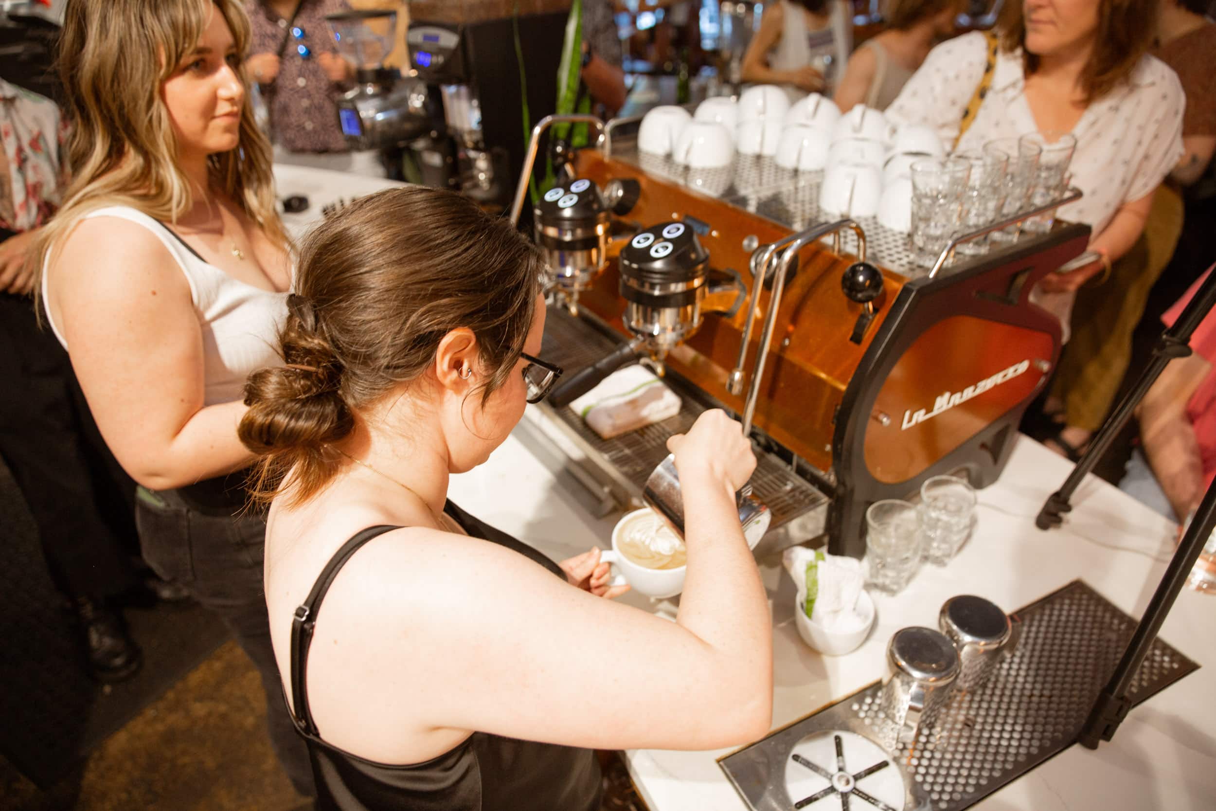 Baristas pouring latte art