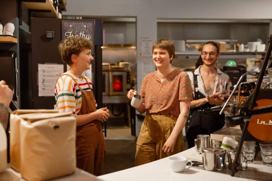 Two baristas smiling and laughing after competition. 