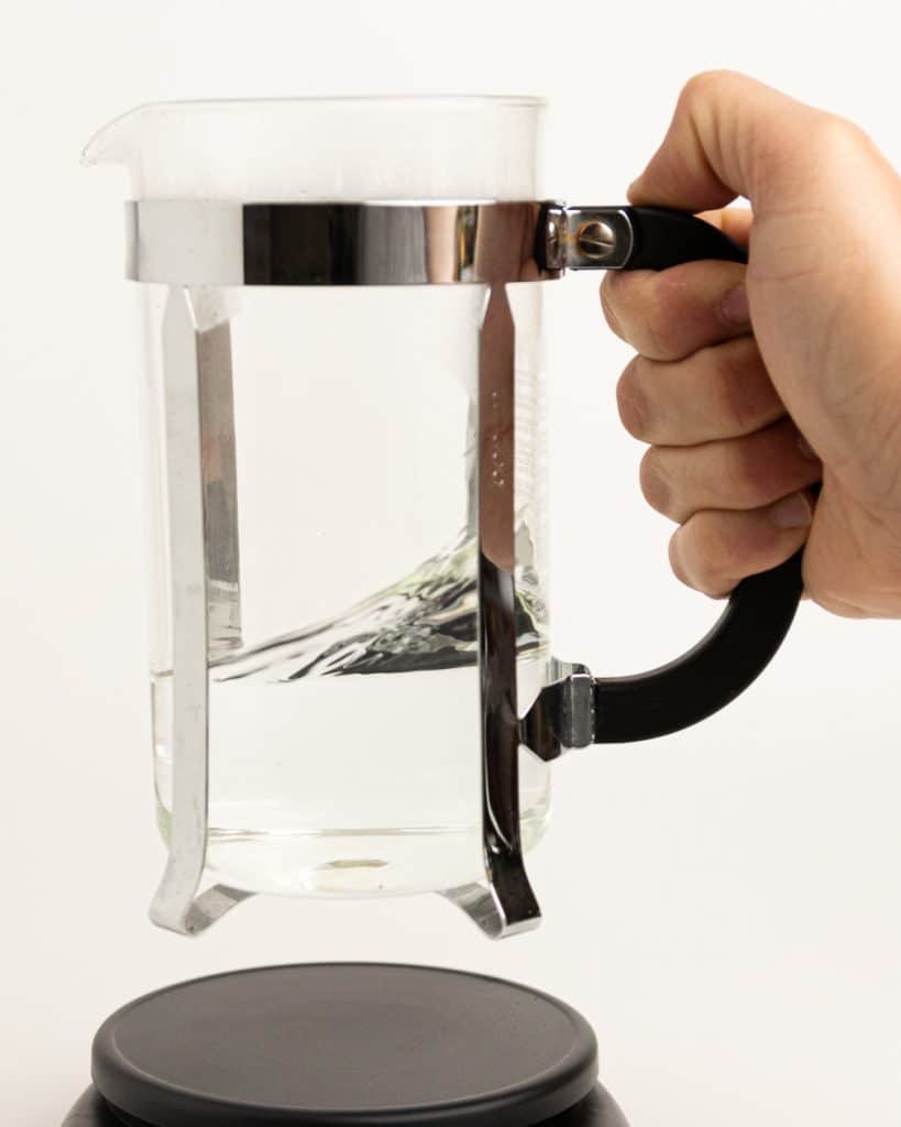water being swirled in a French press base