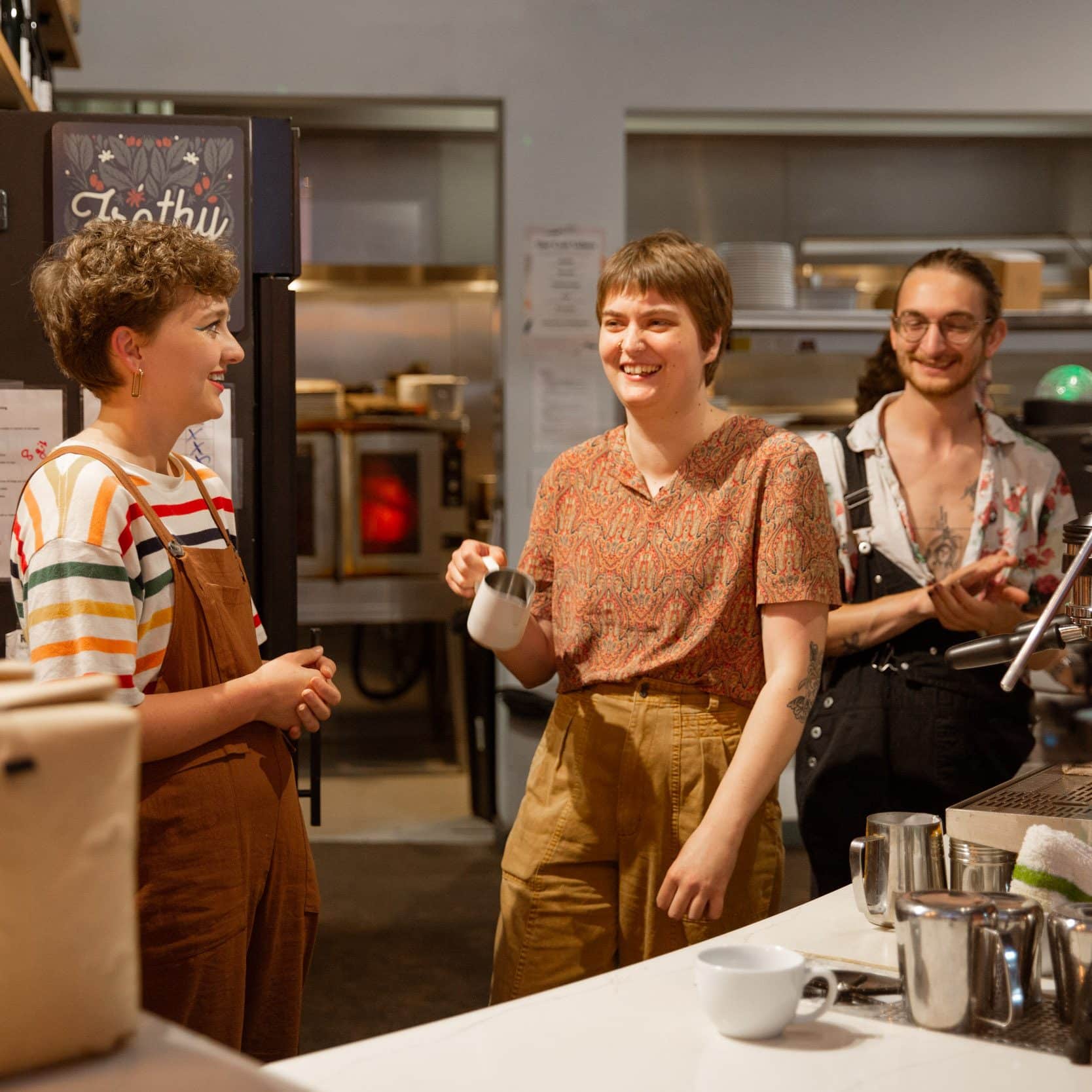 Two baristas smiling and laughing after competition.