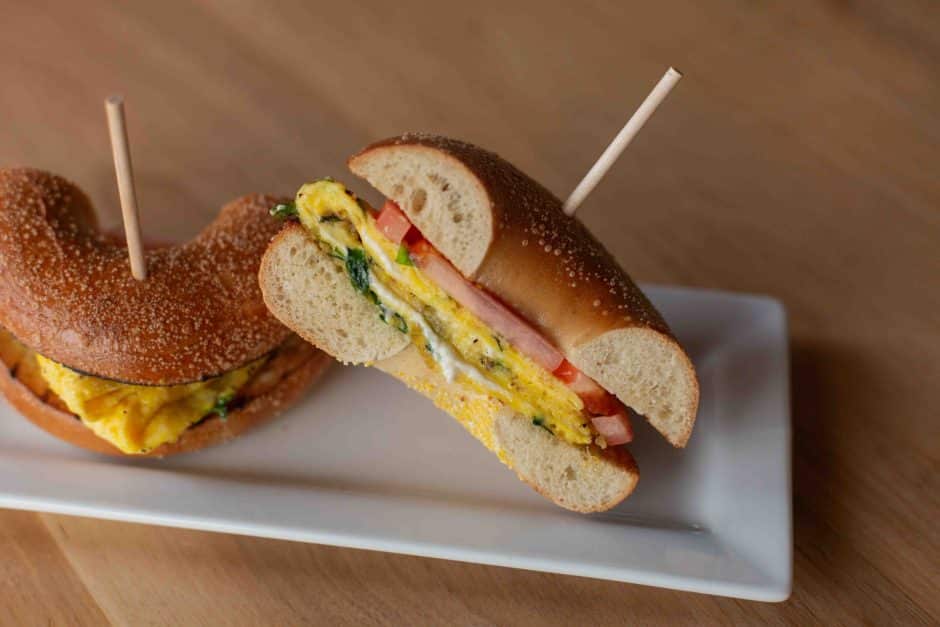 bagel sandwich with egg, tomato and basil